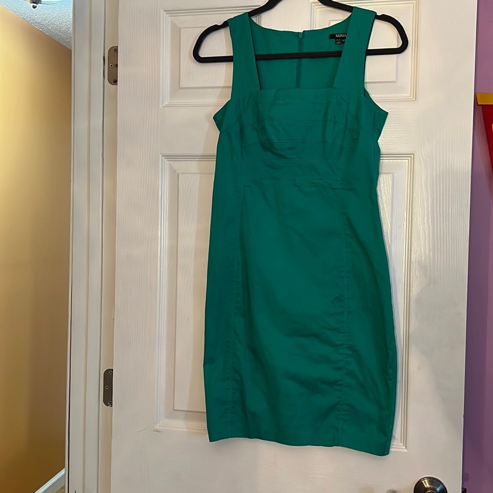 Small green xoxo dress with quarter slit in the back. Conforms to your body